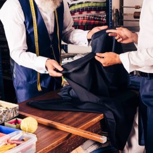 fashion-designer-showing-fabric-his-customer-shop_23-2148180309